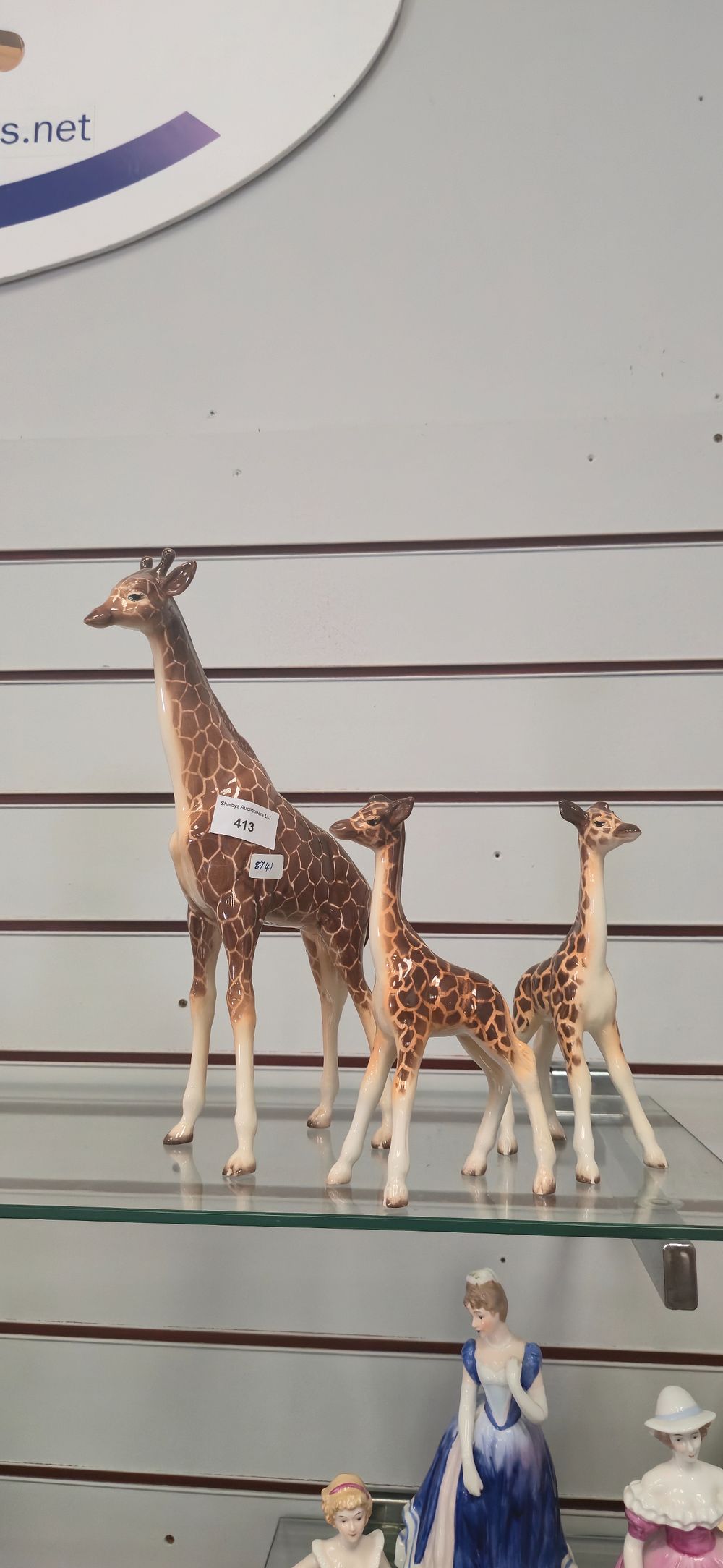 Lot 413: Three. Various beswick giraffe figurines.