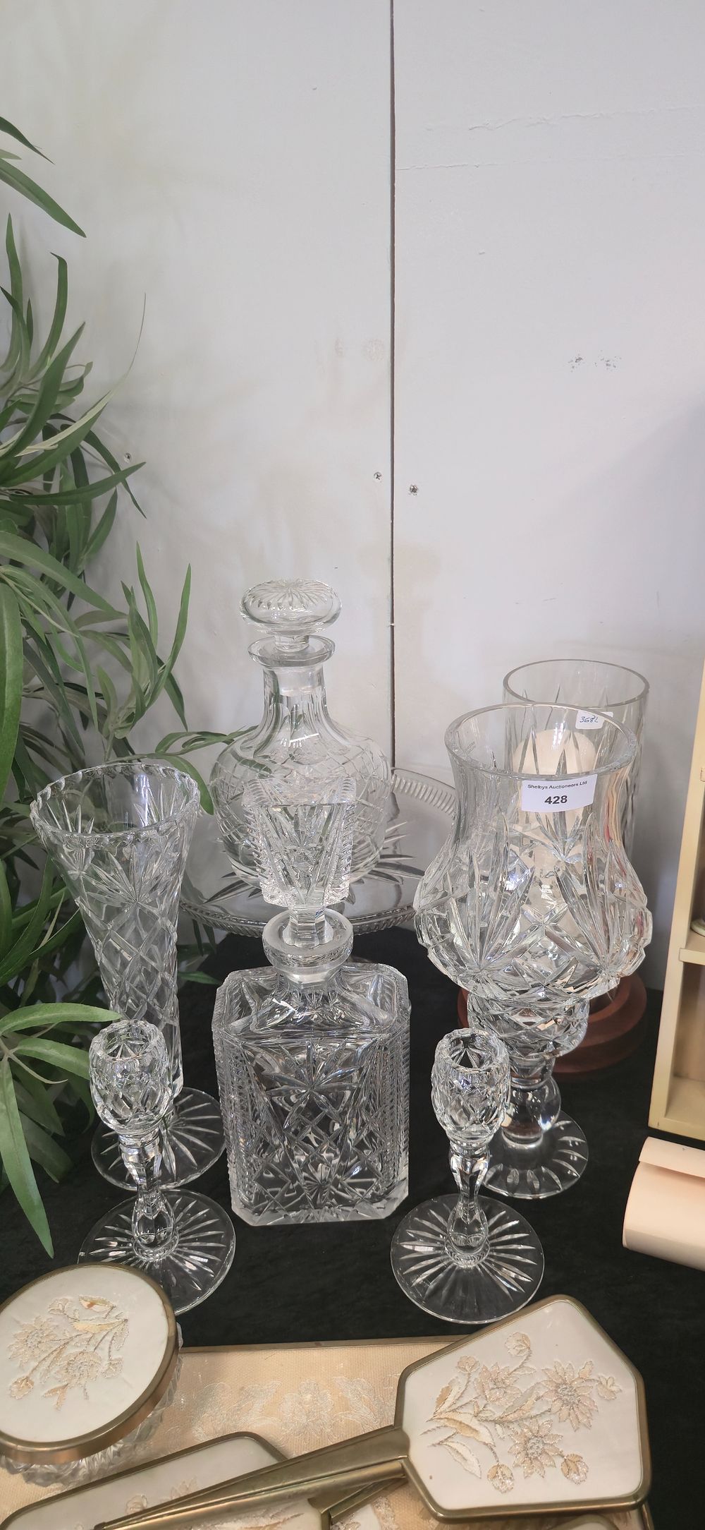 Lot 428: Selection of various crystal, wear items decanters, vases,...