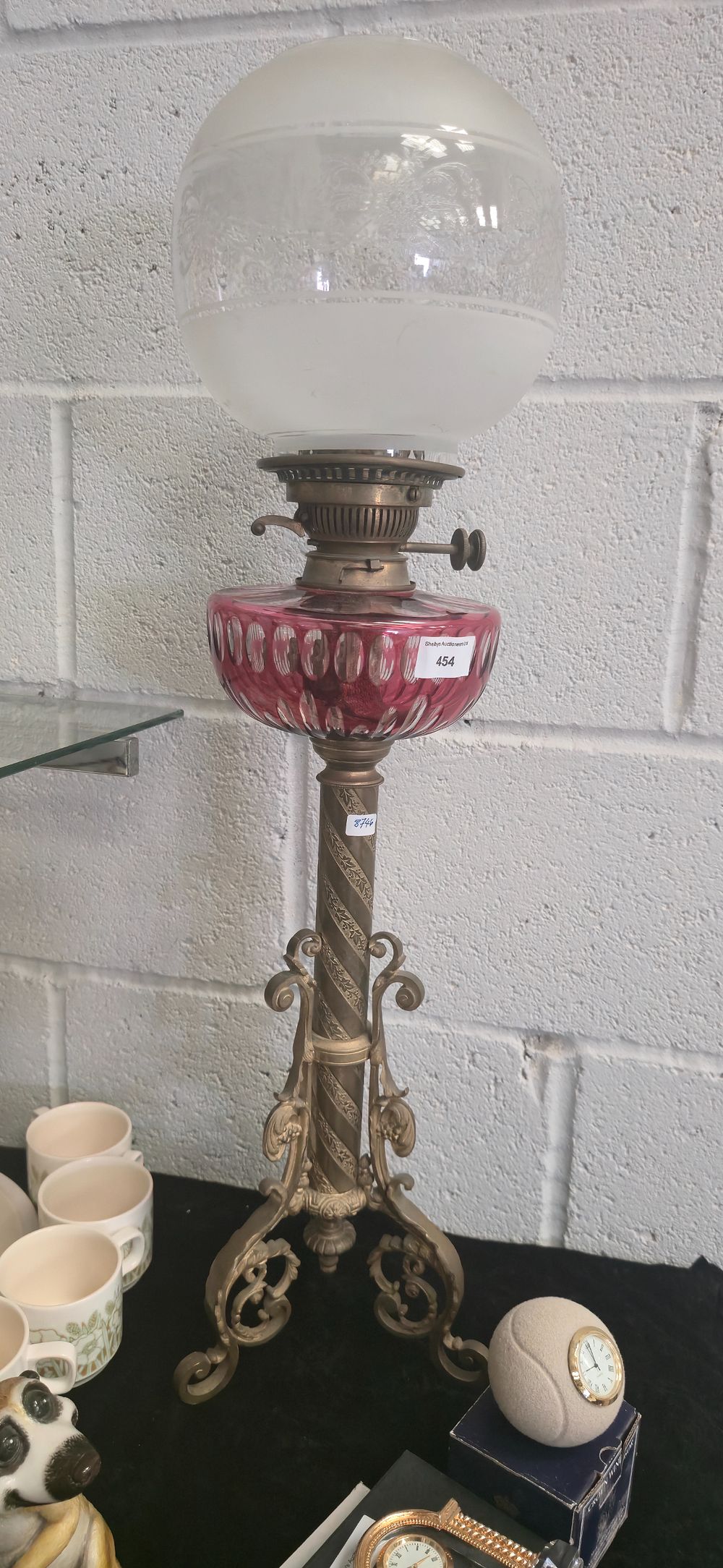 Lot 454: Victorian, brass base, cranberry, glass, paraffin lamp