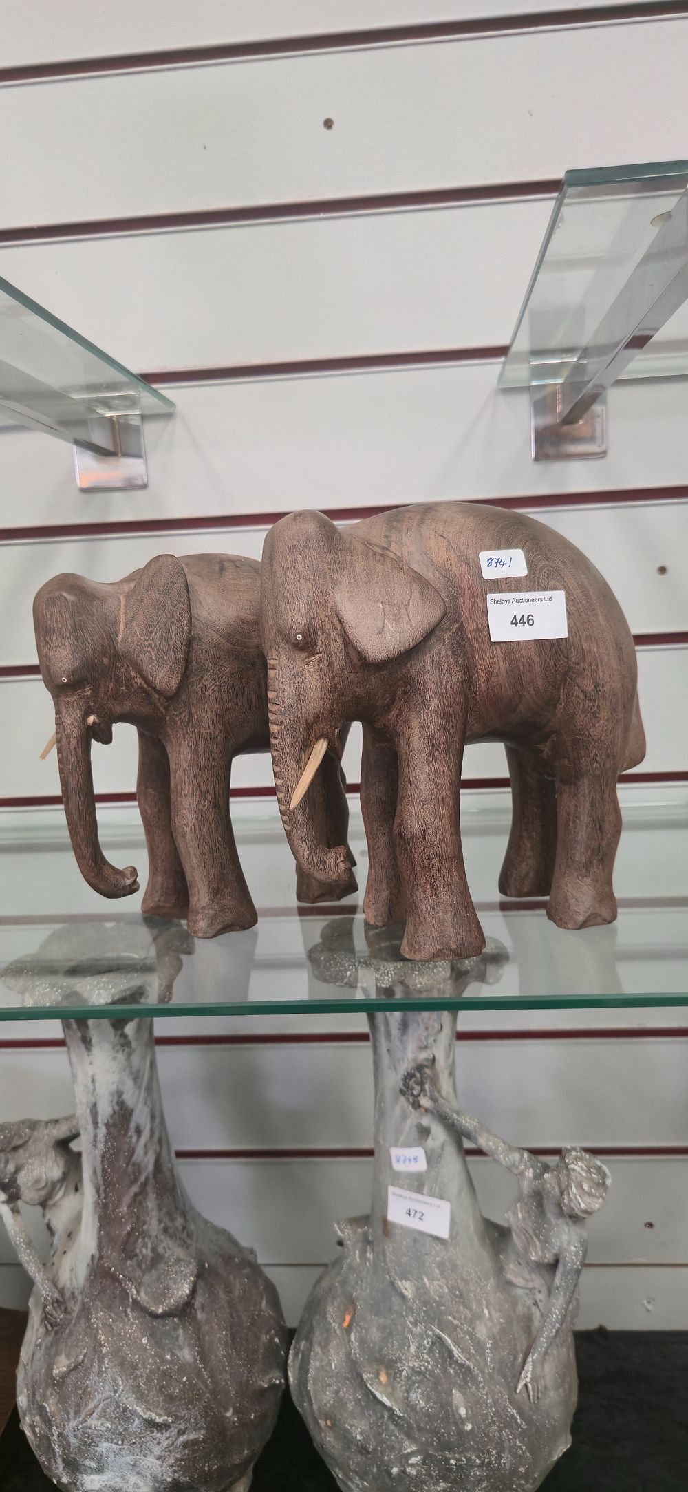 Lot 446: Two large wooden elephant figurine Both have one...
