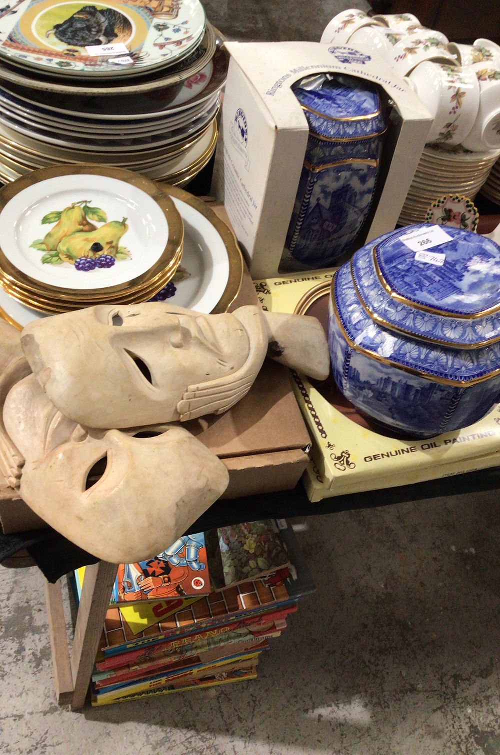 Lot 266: Porcelain Jar, Carved Masks, and Decorative Plates