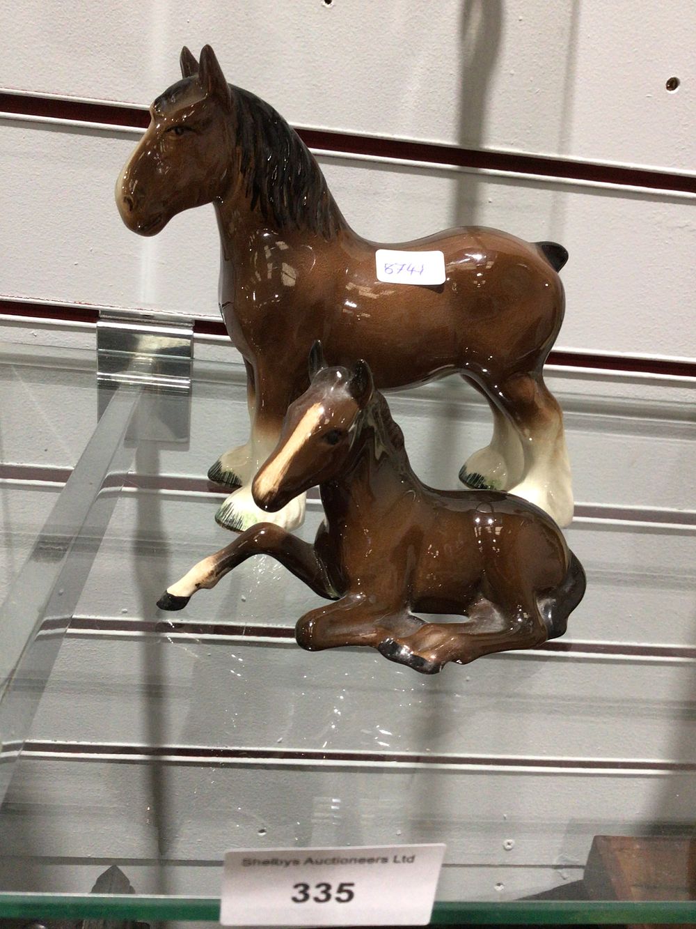 Lot 335: Pair of Glazed Porcelain Horse Figures