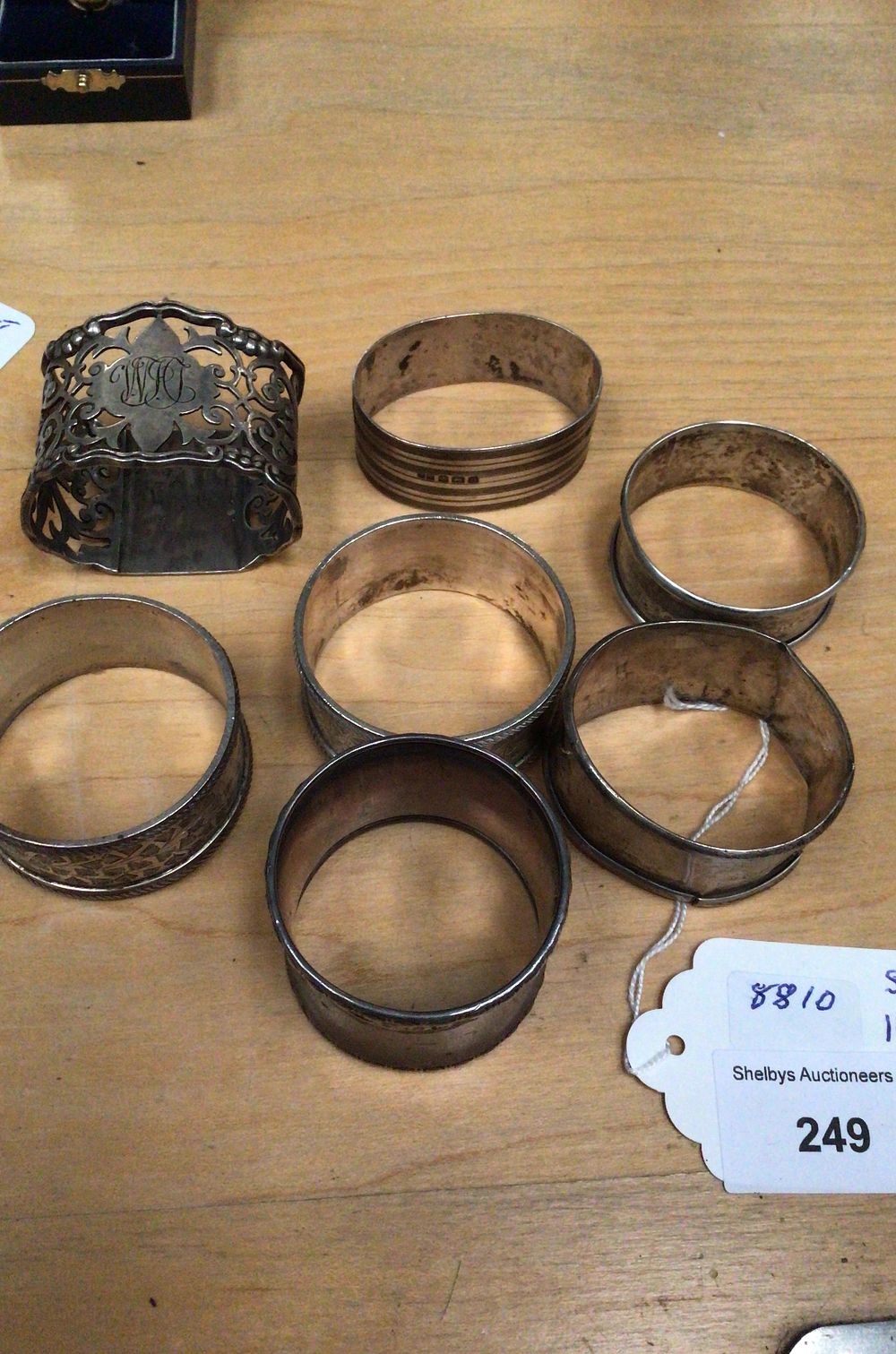 Lot 249: A Group of Seven Silver Napkin Rings, one hallmarked Sterling