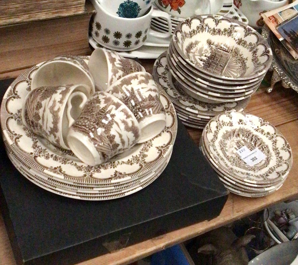Lot 302: A Group of Ten Cream and Brown Transferware Dessert Plates
