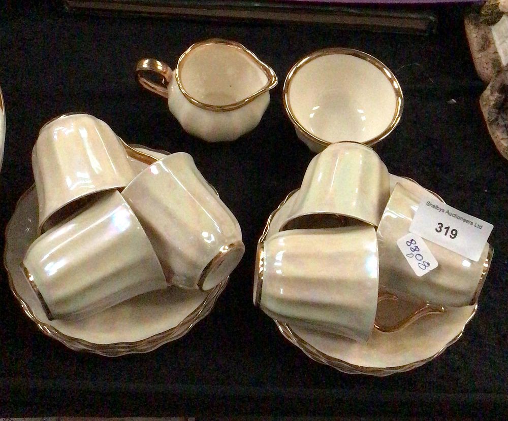 Lot 319: Iridescent Cream Ceramic Teacups, Saucers, Creamer, and Sugar Set