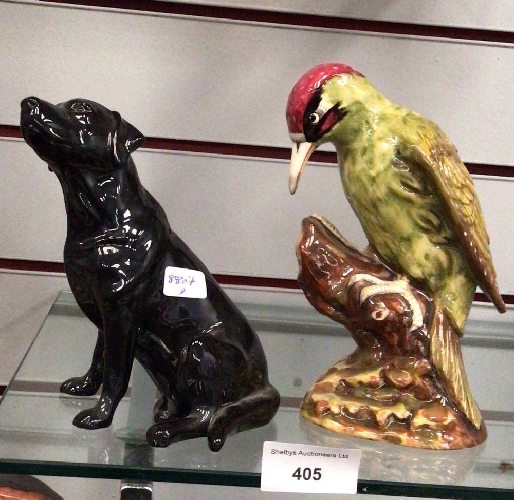Lot 405: Two Ceramic Figurines: A Black Beswick Labrador and a Royal Doulton Bird