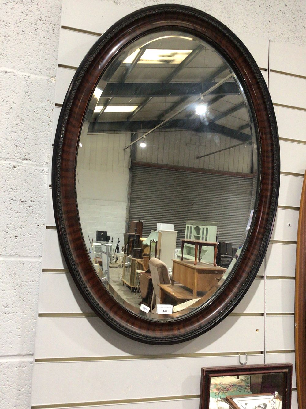 Lot 164: Victorian bevelled edged wood surround oval mirror