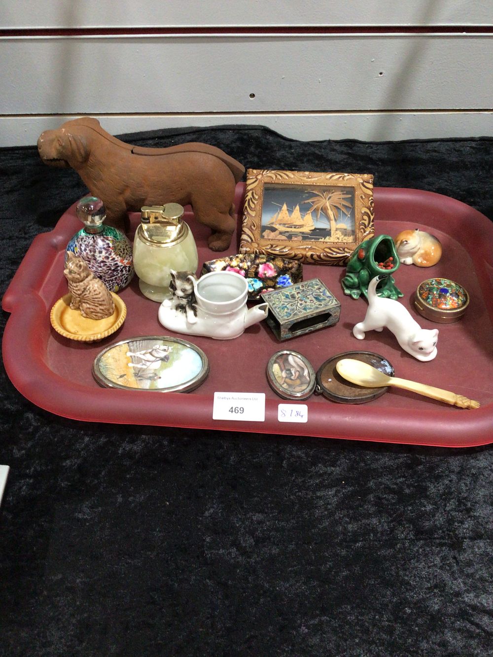 Lot 418: Tray containing dog, nutcracker, alabaster, lighter paperweight et cetera