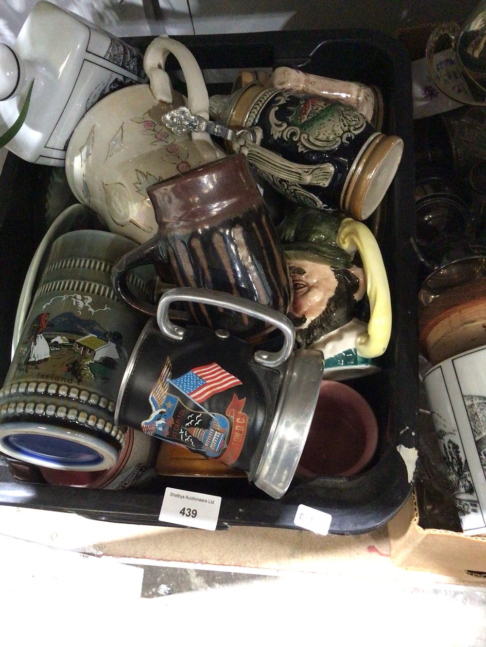 Lot 322: Box containing large amount of pottery where Toby jugs steins et cetera