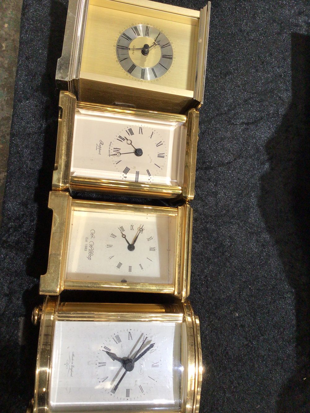 Lot 320: A Group of Four Brass Quartz Travel/Desk Clocks