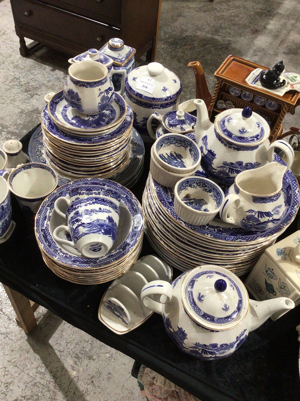 Lot 314: A Group of 61 Piece Blue and White Willow Pattern Ceramic Ware