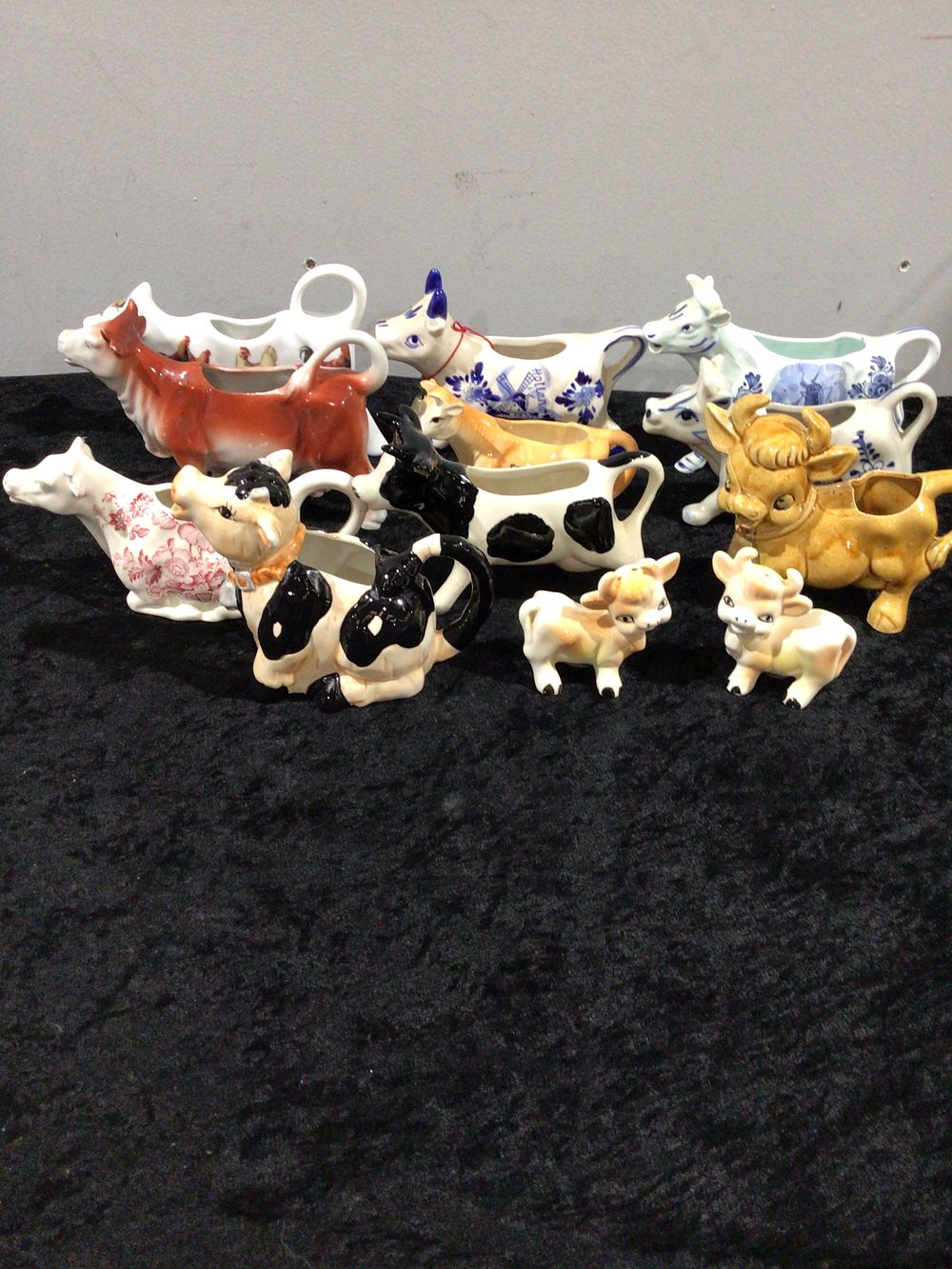 Lot 229: A Group of Fourteen Glazed Ceramic Cow Creamers and Calf Figurines