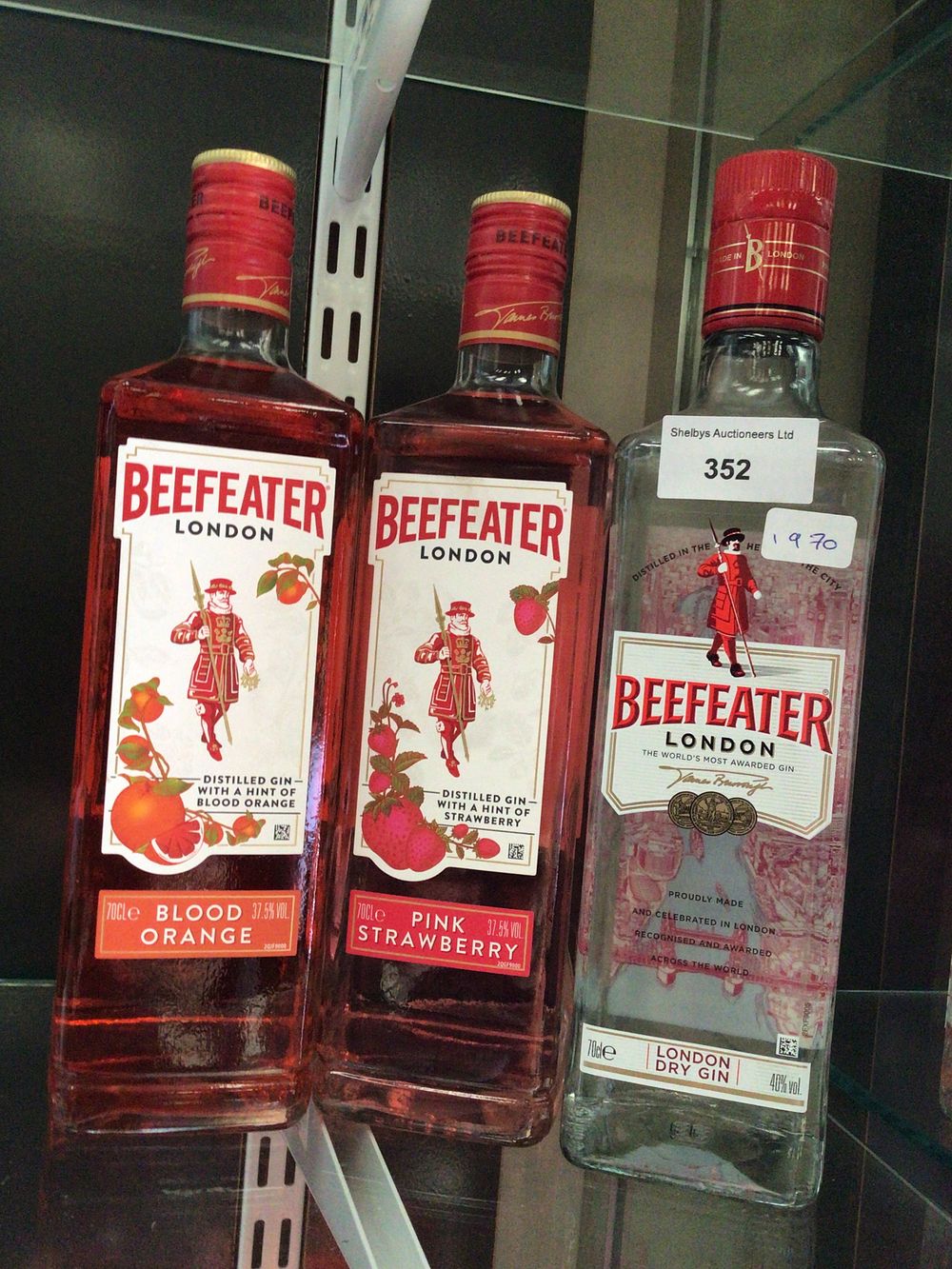 Lot 352: Three Bottles of Beefeater London Gin, comprising London Dry, Pink Strawberry, and Blood Orange