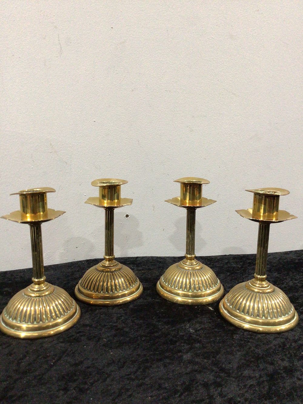 Lot 278: A Set of Four Antique English Brass Candlesticks