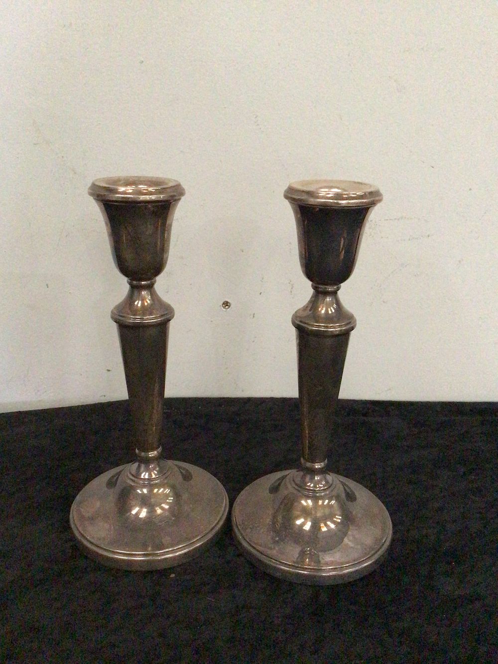 Lot 217: A Pair of Empire Weighted Sterling Silver Candlesticks