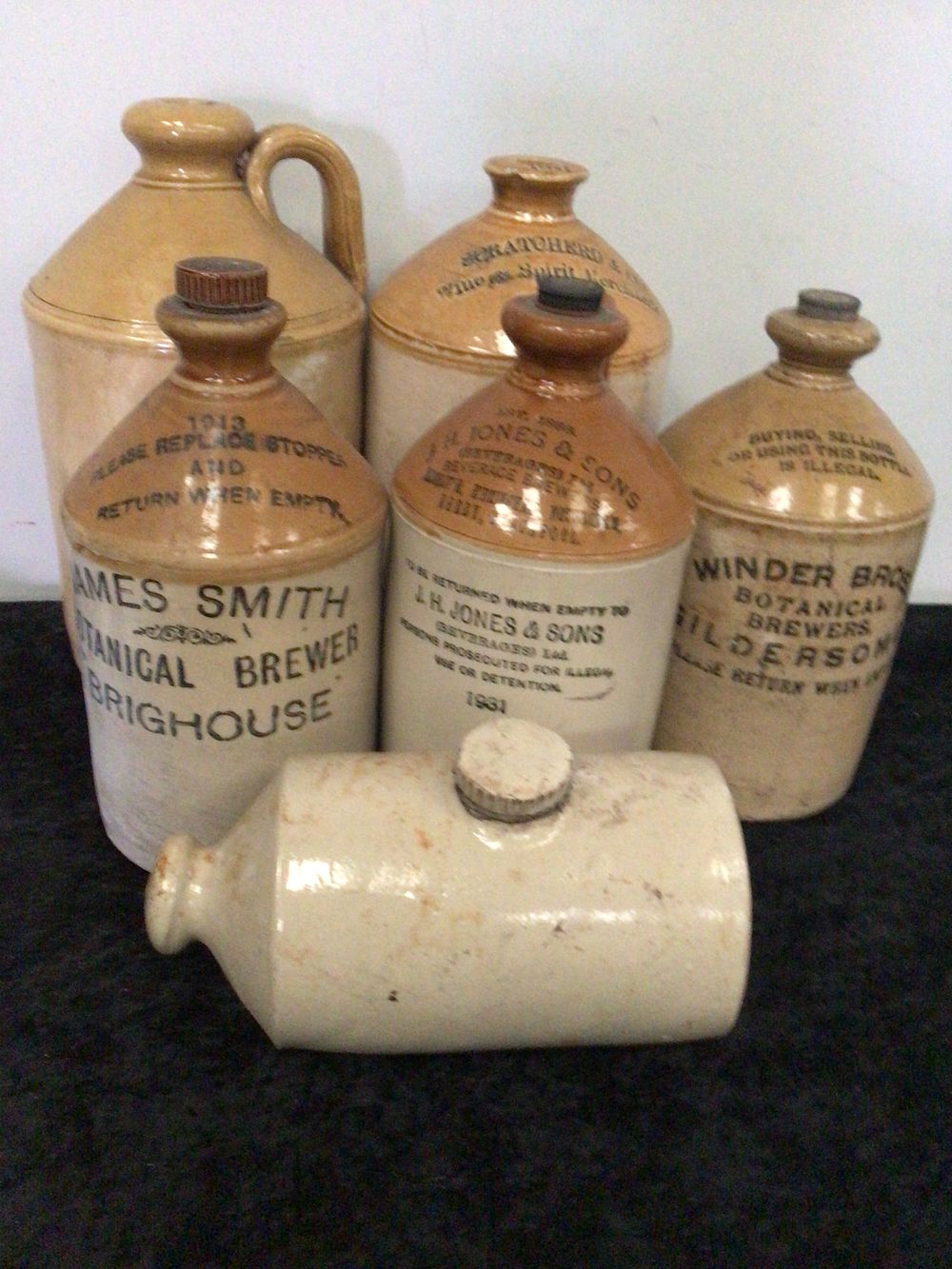 Lot 252: A Group of Six Early 20th-Century Salt-Glazed Stoneware Bottles and Flagons
