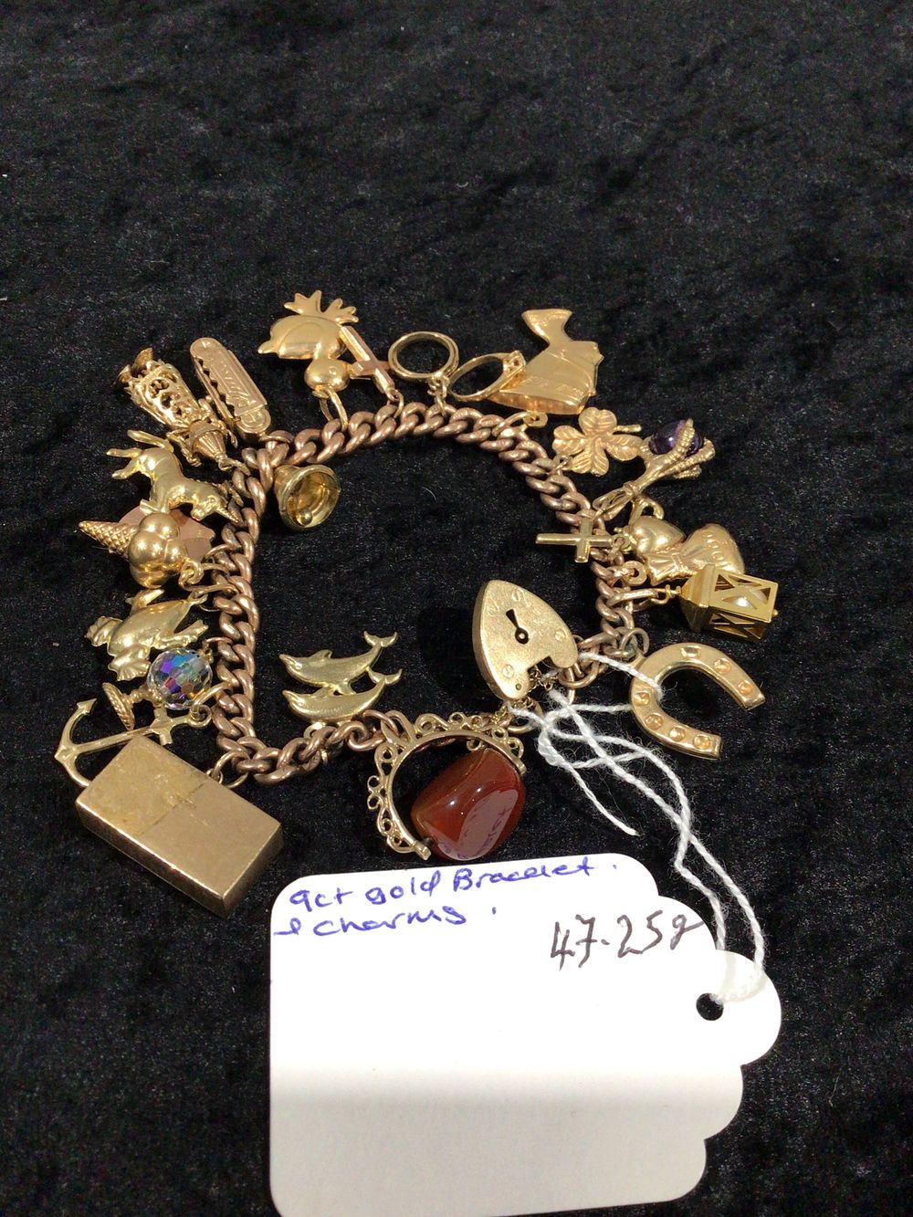 Lot 398: A Vintage 9ct Gold Charm Bracelet with a Collection of Charms