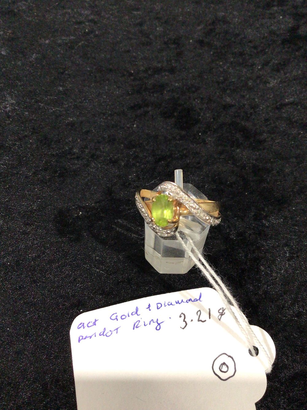 Lot 399: A Two-Tone Gold Peridot and Diamond Bypass Ring