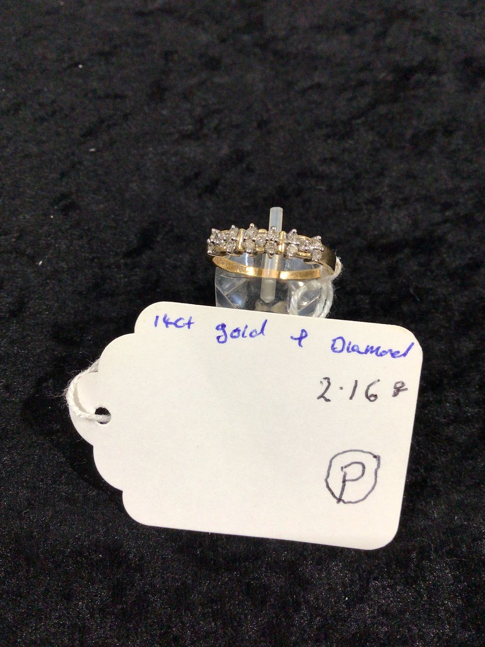 Lot 402: A 14 Karat Gold and Diamond Band Ring