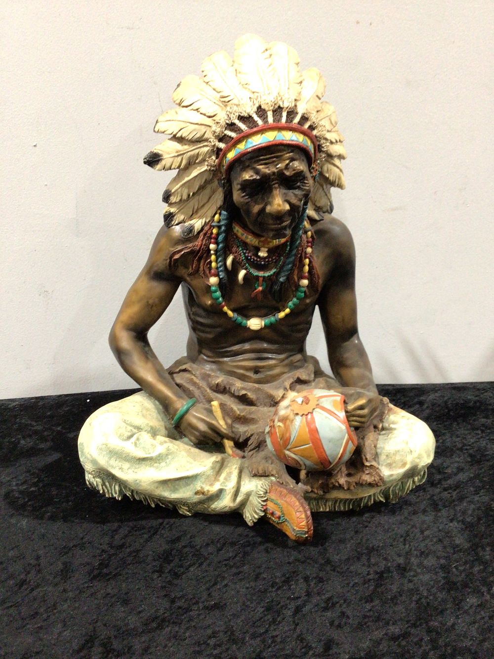 Lot 262: A Native American Chief Figurine, Seated with Drum