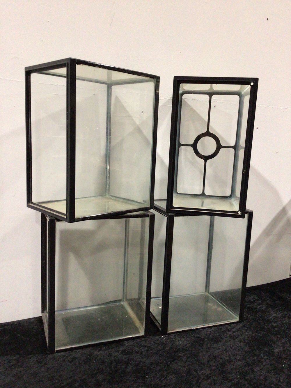 Lot 267: A Set of Four Clear Glass and Black Frame Display Cases