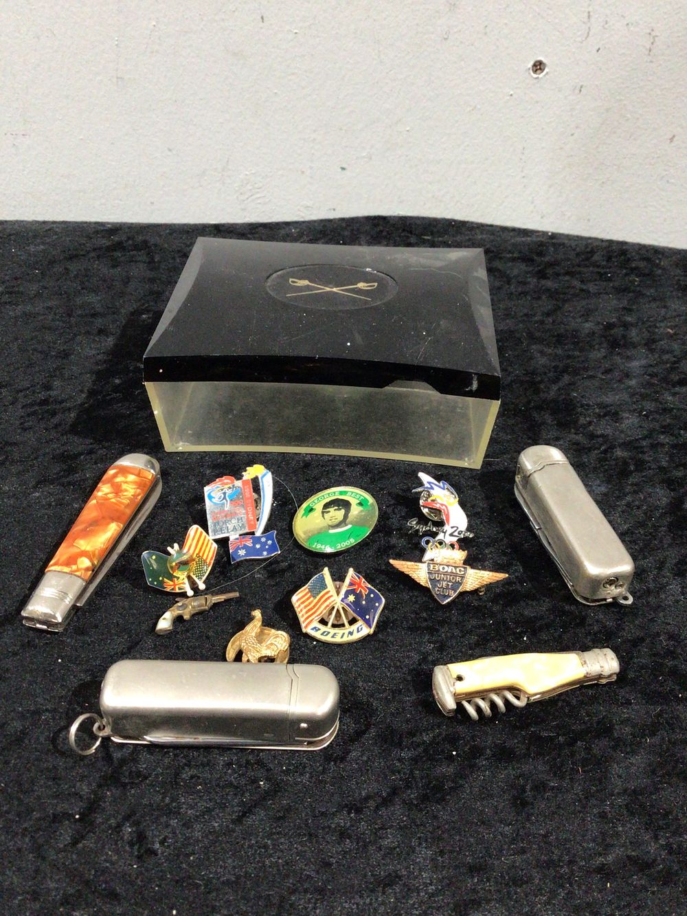 Lot 412: A Collection of Pins, Multi-Tools, and Storage Box