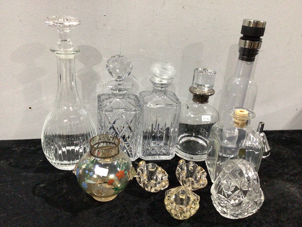 Lot 192: A Collection of Clear Glass and Crystal Decanters and Decorative Items One Silver Topped