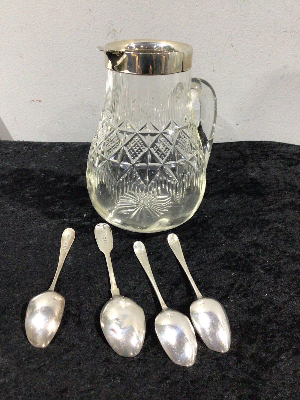 Lot 237: Vintage Cut Crystal Glass Pitcher with Silver-Toned Rim and Four Associated Spoons, One .800 Silver