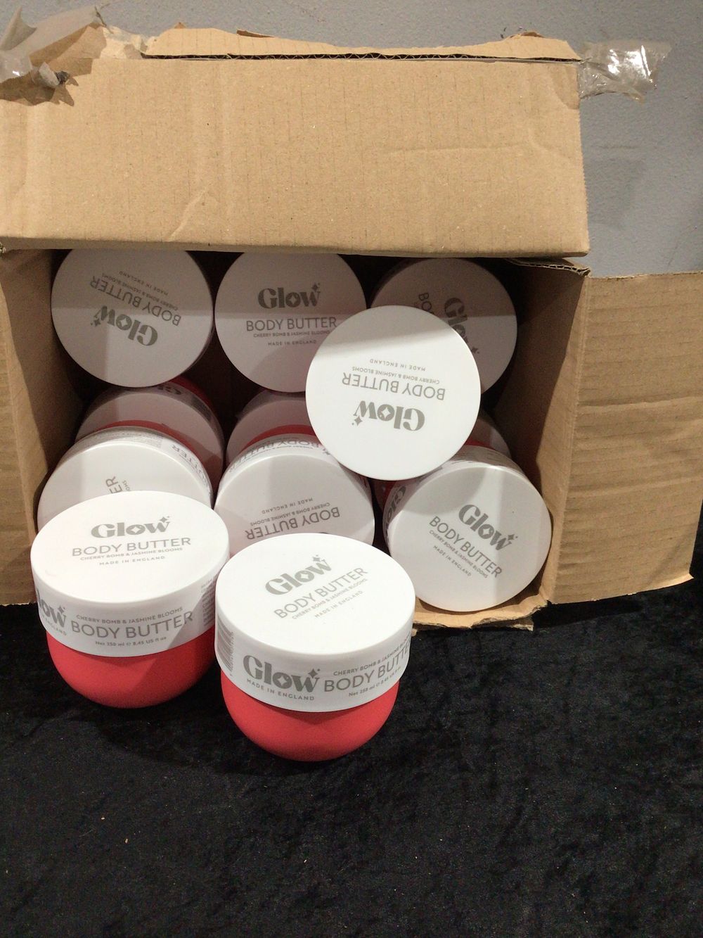 Lot 357: A Set of 12 Glow Body Butter Cherry Bomb & Jasmine Blooms, 250ml