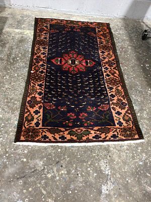 Antique Persian Sarouk Rug. An Antique Persian Sarouk rug, a rectangular woven textile with a 