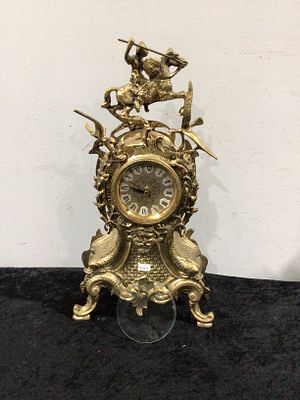 A Neo-Baroque Style Brass Mantel Clock with Mounted Knight Finial. This ornate mantel or table 