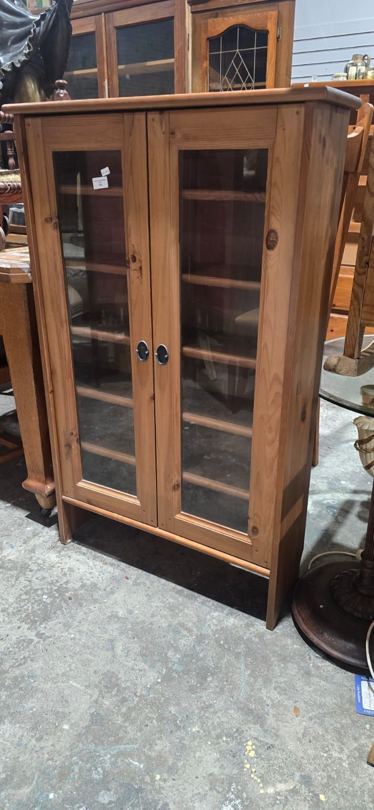 Lot 165: A Contemporary Pine Two-Door Display Cabinet with Glass Panels