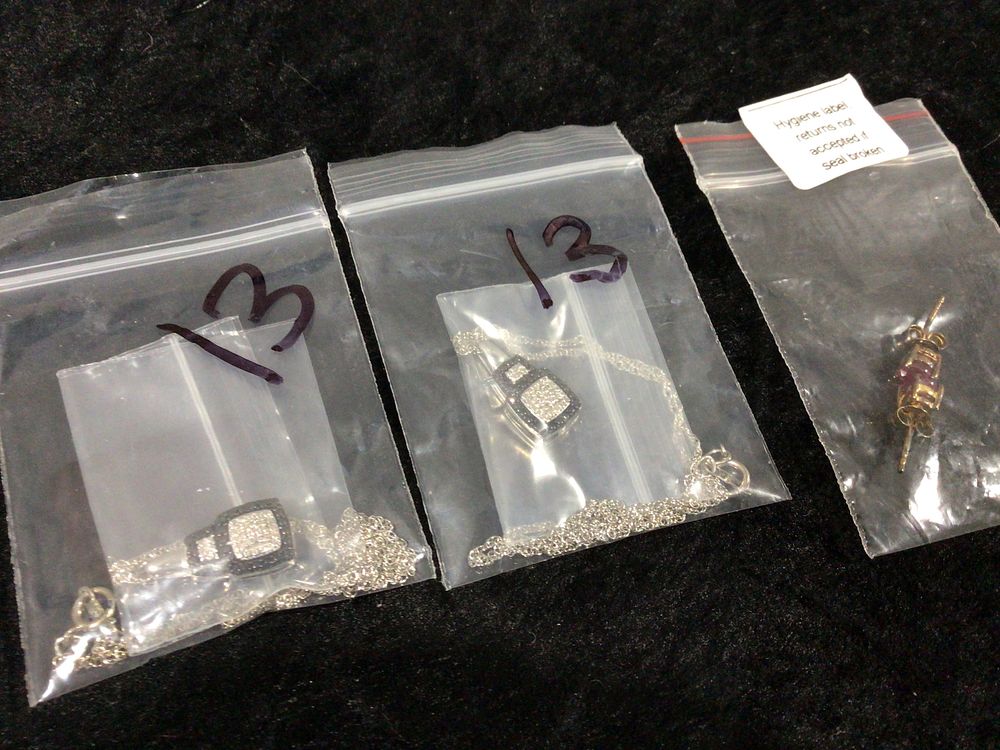 Lot 337: Two Sterling Silver Pave-Set Cubic Zirconia Pendant Necklaces and a Pair of Sterling Silver Inset Earrings with Red Stones