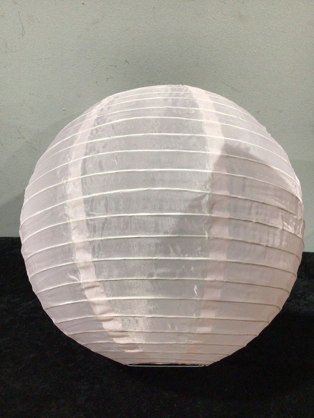 Lot 170: A Collection of 60 White Fabric 16-Inch Round Lanterns
