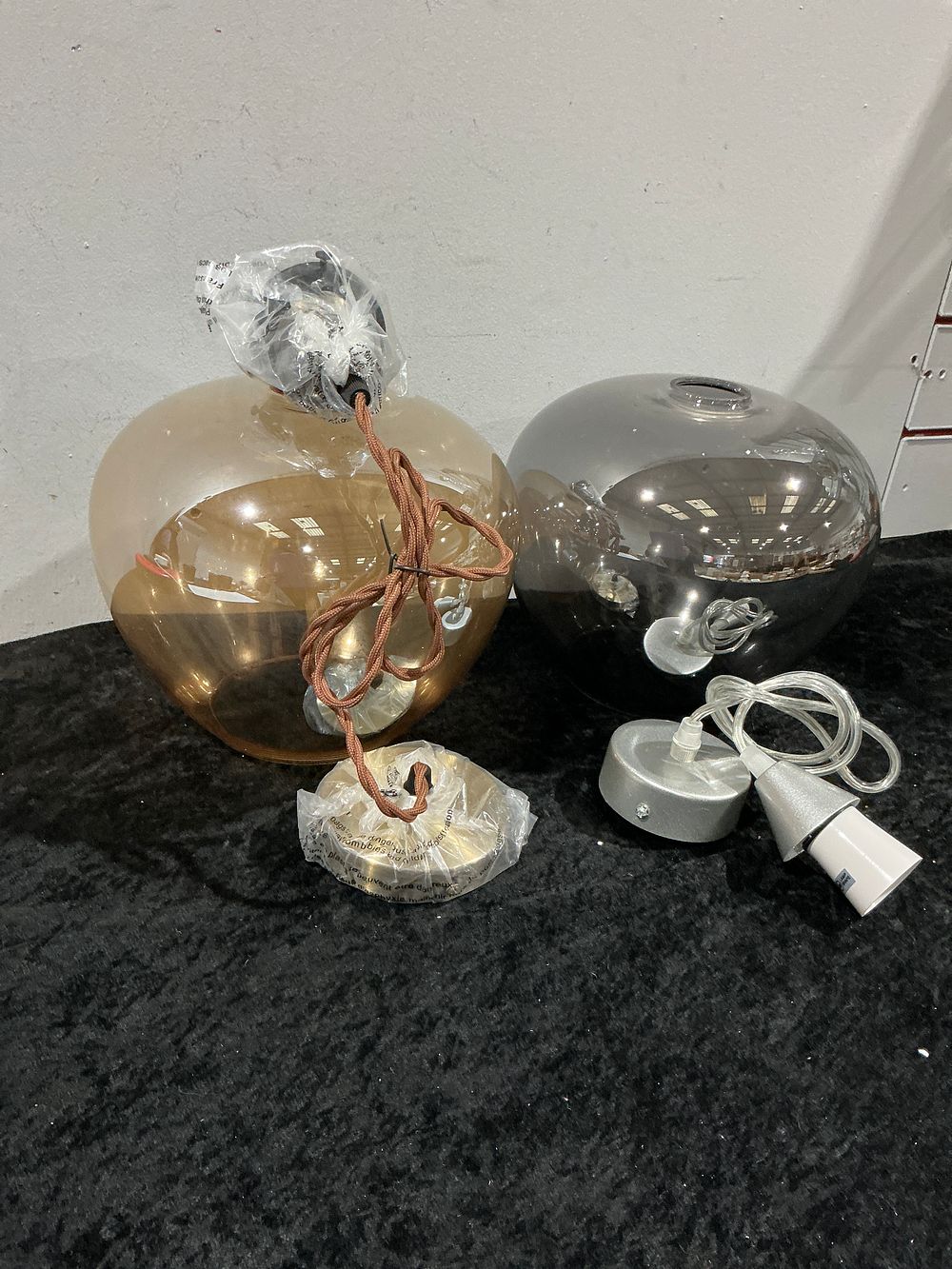 Lot 180: A Pair of Contemporary Blown Glass Globe Pendant Lights
