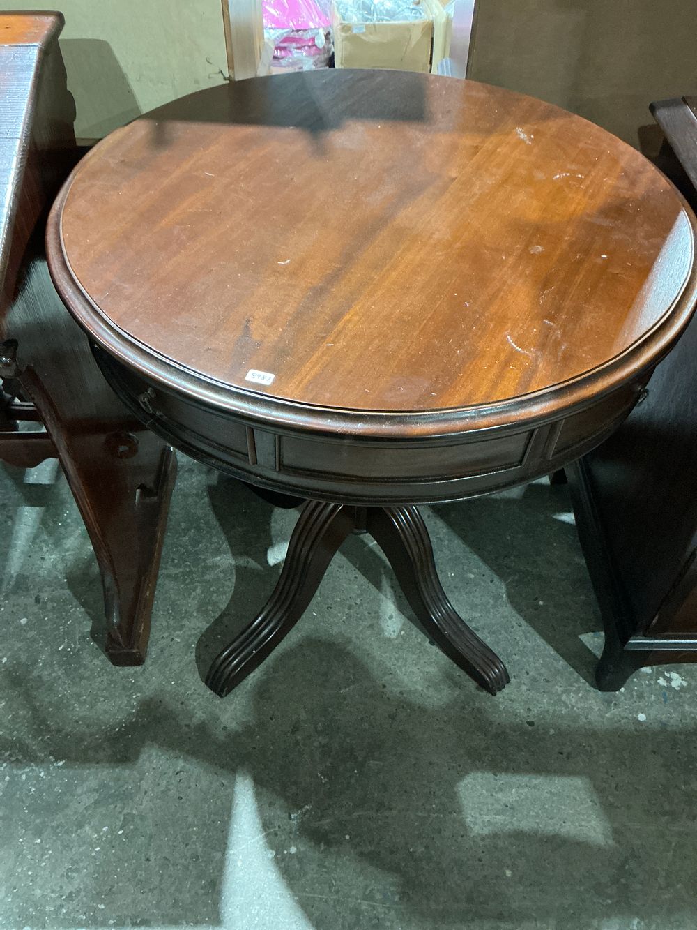 Lot 235: A Dark Finished Wood Pedestal Table with Tripartite Base