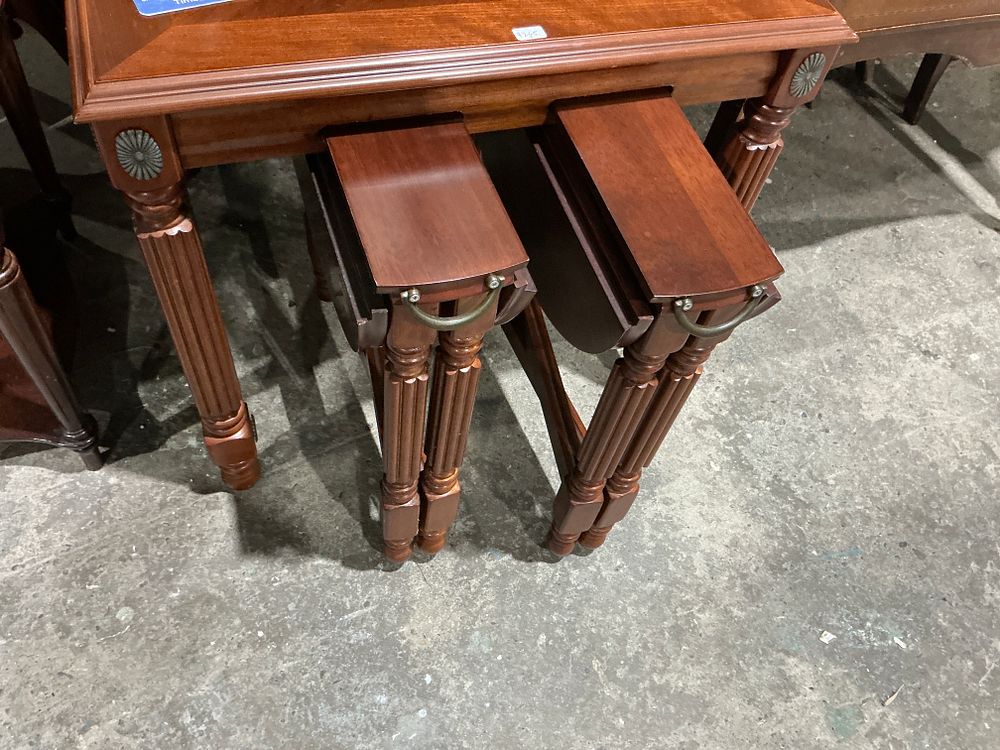 Lot 253: A Three Piece Nesting Drop-Leaf Table Set
