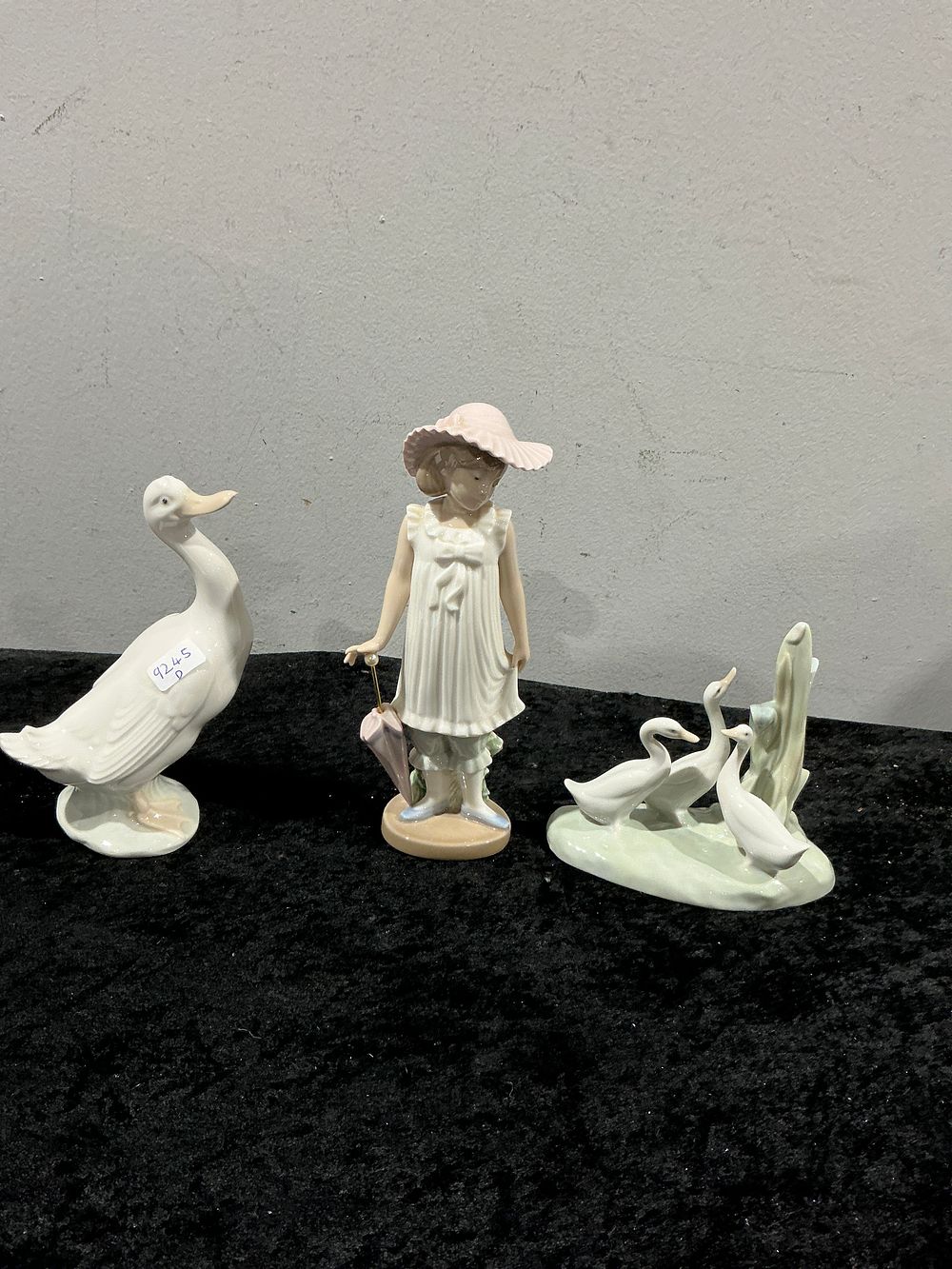 Lot 264: A Trio of NAO by Lladro Porcelain Figurines including April Showers Model 1126