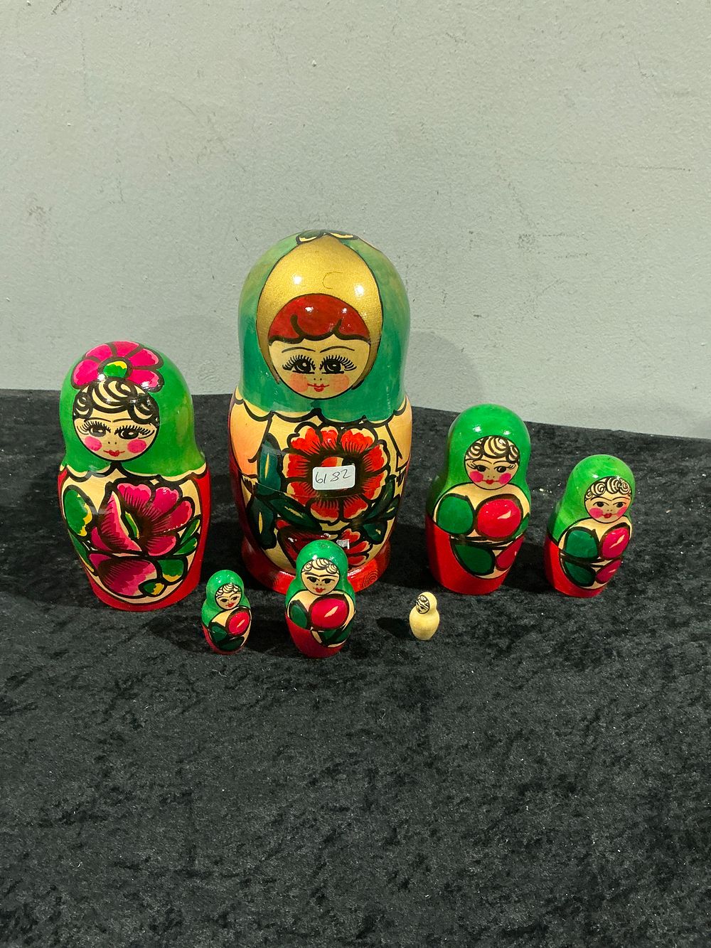 Lot 265: A Collection of Seven Kirov Green Scarf Russian Matryoshka Nesting Dolls and Figurines