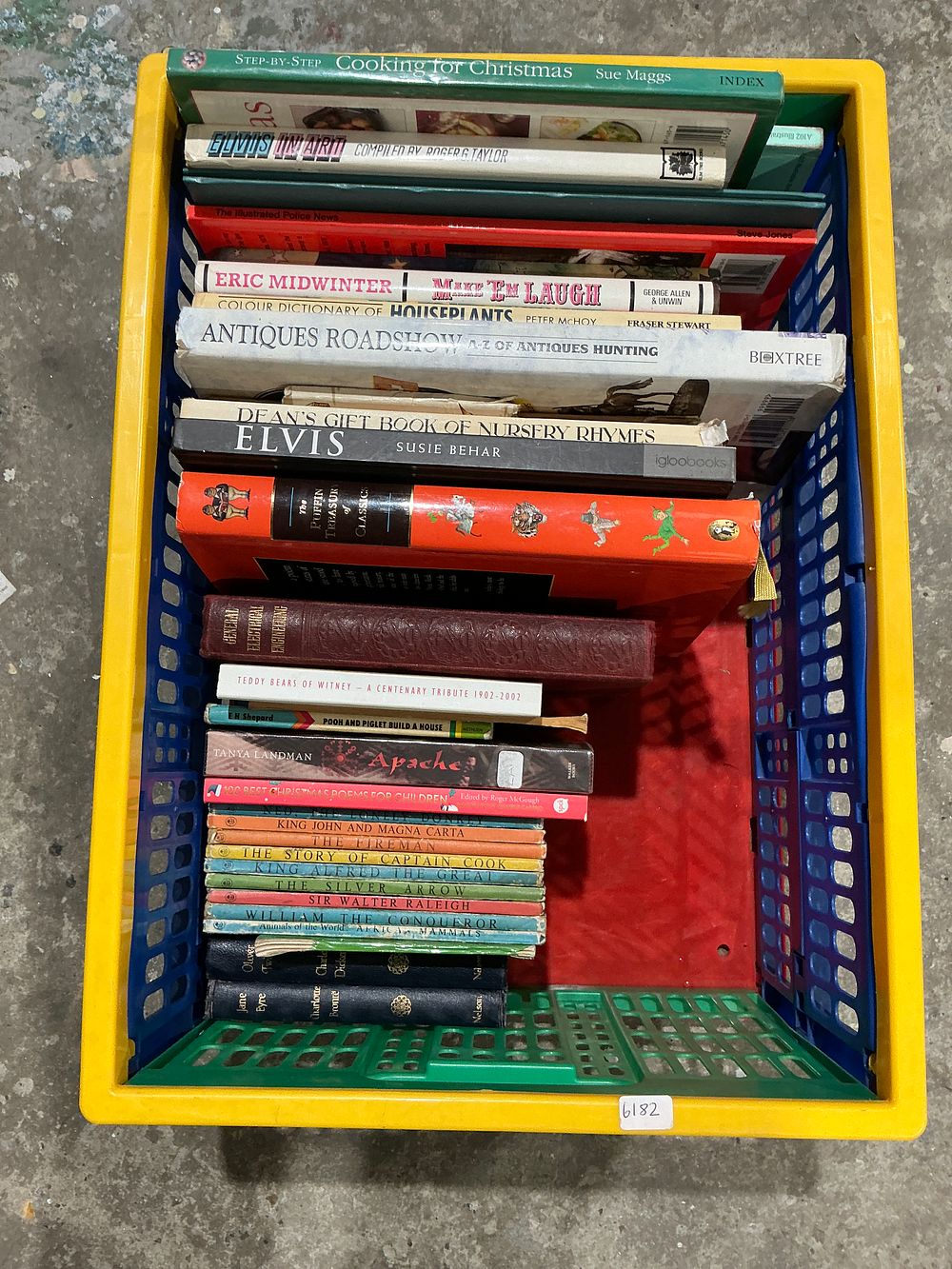 Lot 390: A Collection of 26 Assorted Books in a Multi-Colored Plastic Crate