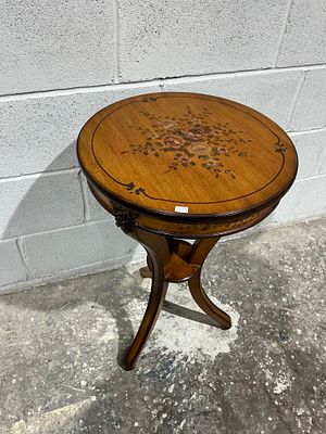 A Painted Wooden Pedestal Occasional Table with Floral Decoration. A round wooden occasional 
