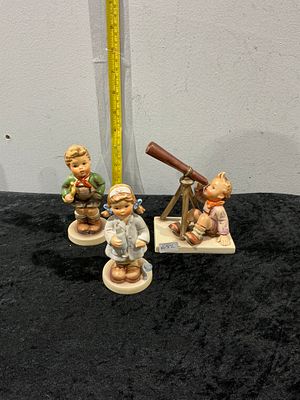 Goebel Hummel, A Collection of Three Figurines: Star Gazer, Little Nurse, and Trumpet Boy. A lot 