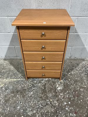 A contemporary light wood chest of five drawers. A contemporary small chest of drawers 