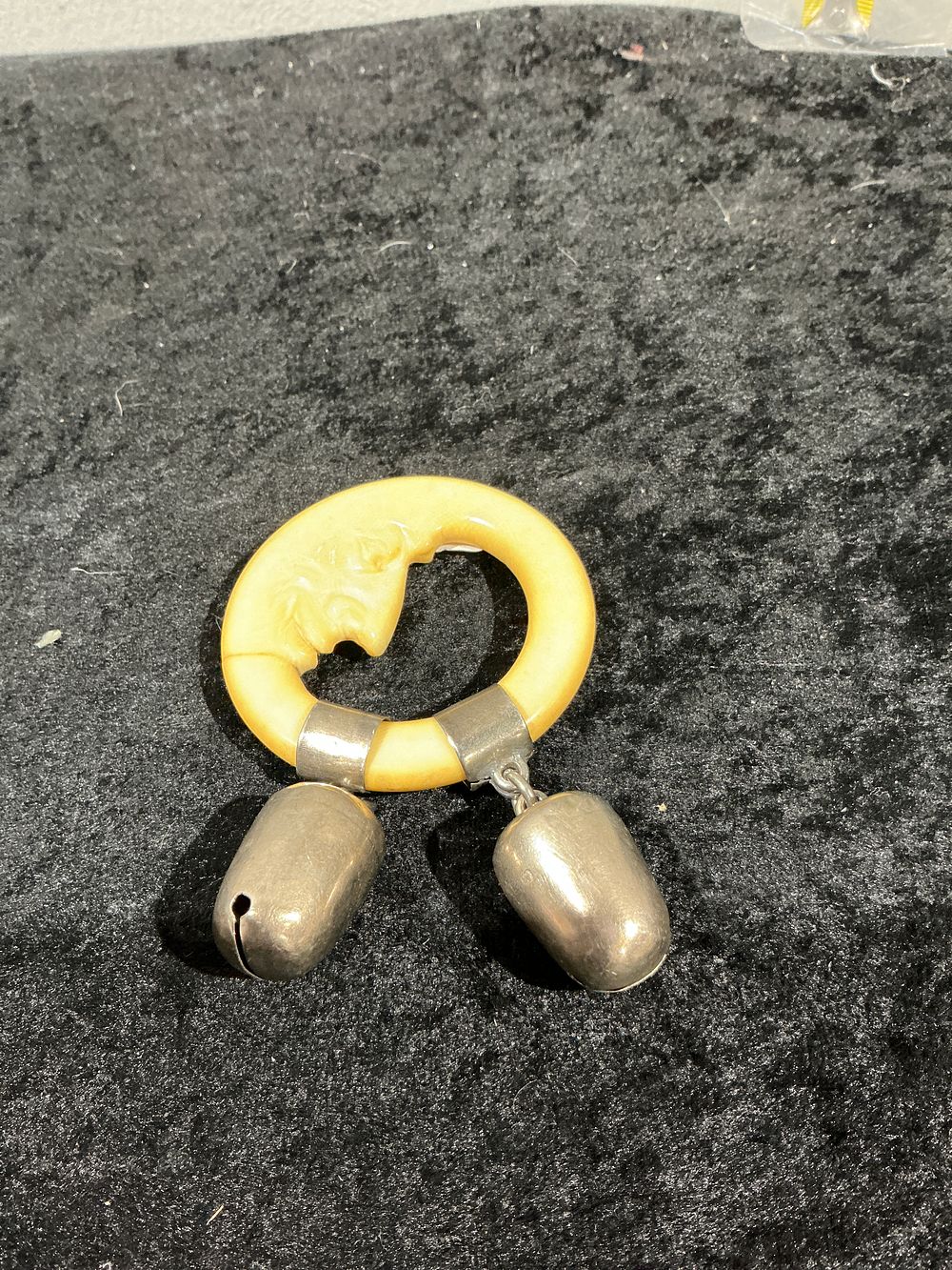 Lot 337: A Victorian Style Silver and Moulded Celluloid Man in the Moon Baby Rattle and Teething Ring