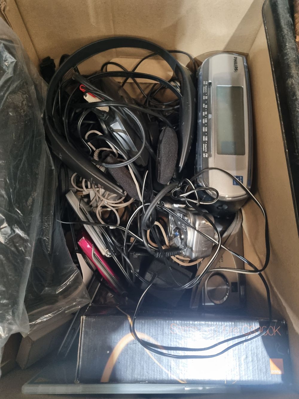 Lot 165: An Assortment of Consumer Electronics including a Philips Alarm Clock Radio, Mobile Handsets, and Accessories