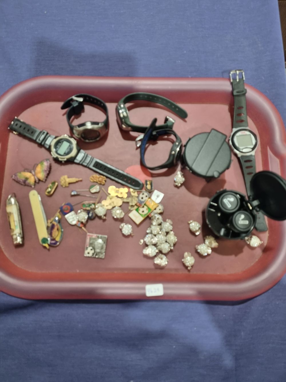 Lot 217: An Assortment of Digital Wristwatches, Wireless Earbuds, and Miscellaneous Collectibles