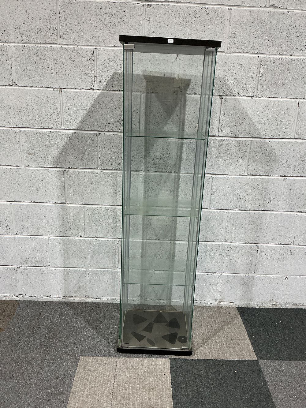 Lot 190: A contemporary tall glass display cabinet with black laminate base and top