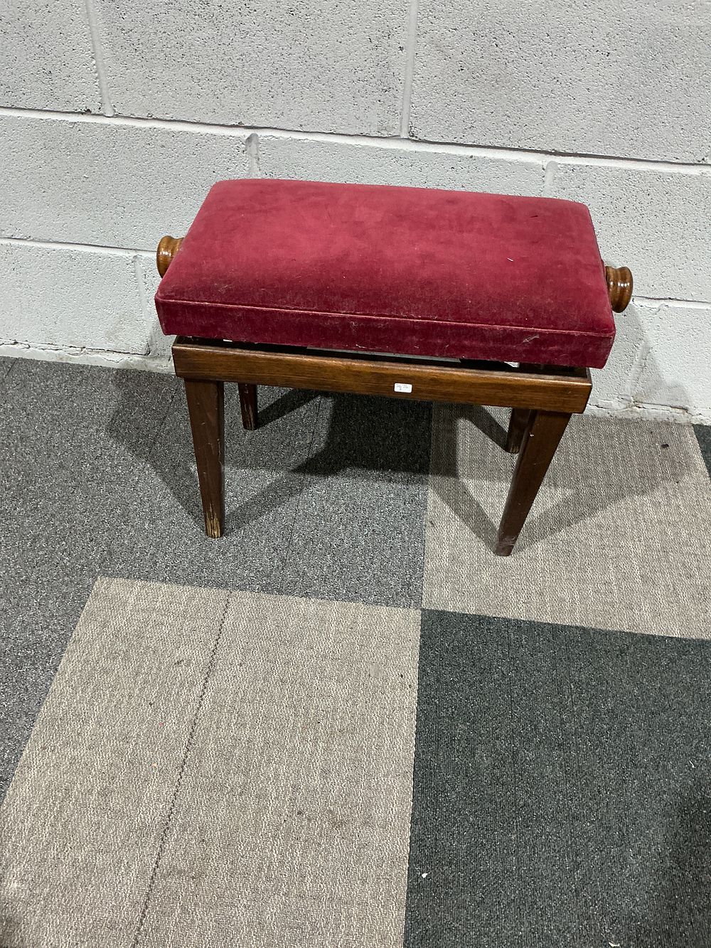 Lot 191: A mid-20th-century adjustable piano stool with red velvet upholstery