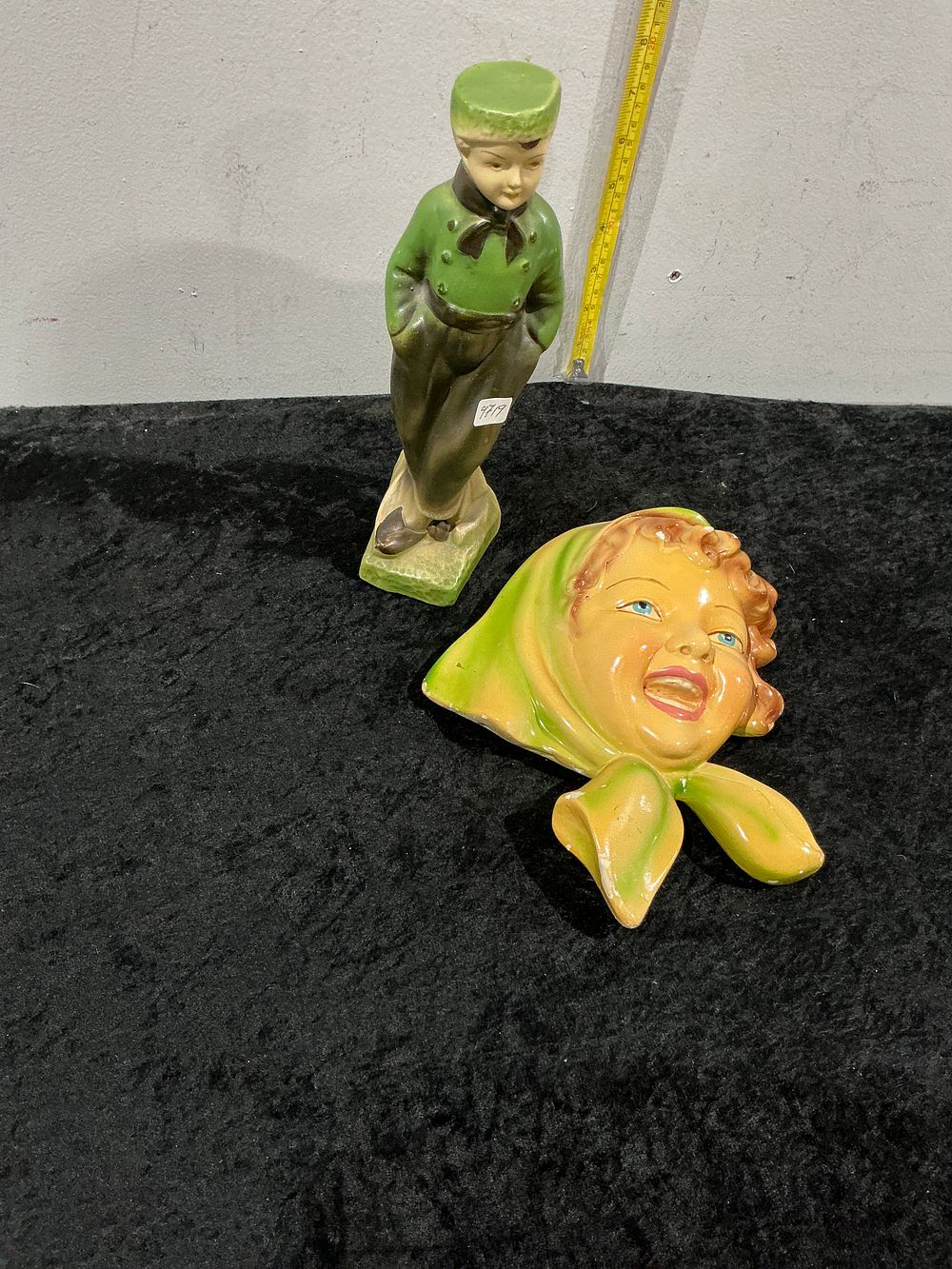 Lot 474: Two mid-20th-century decorative glazed ceramic items including a standing figurine of a boy and a child's face wall mask