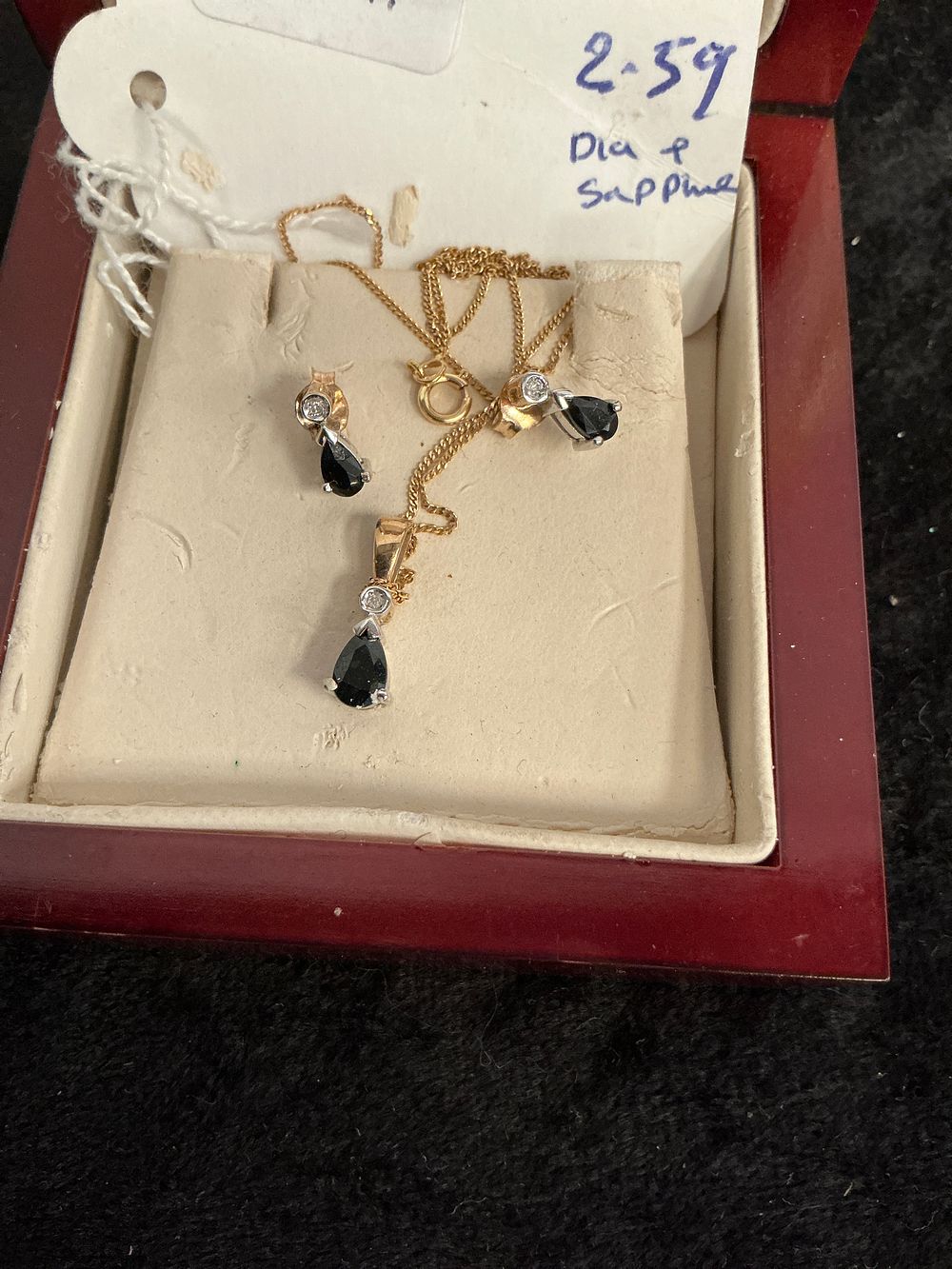 Lot 196: A 9 Carat Gold Black Sapphire and Diamond Pendant Necklace and Earring Set